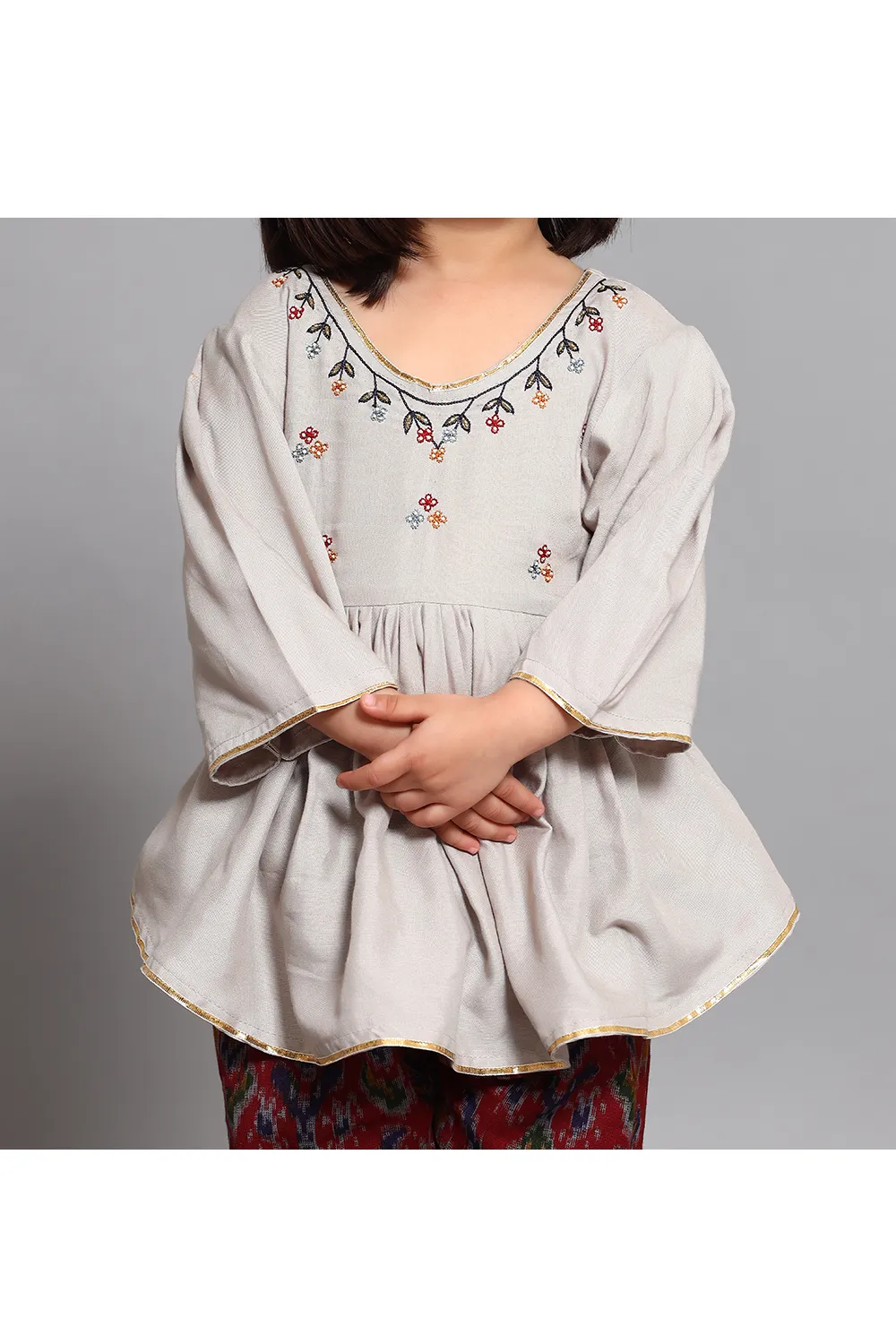 Grey peplum style kurta with red printed pants